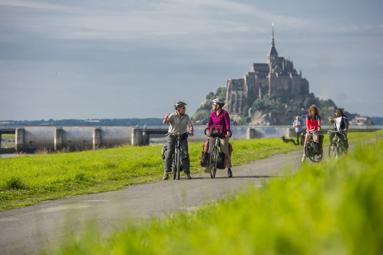 Cyclists in front of Mont-Saint-Michel